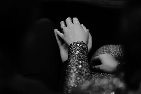 grayscale photo of man and woman holding each other hands thumbnail