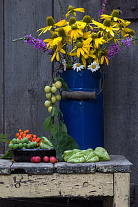 photography of yellow flowers in blue metal vase thumbnail