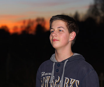 selective focus photography of man wearing black and gray pullover hoodie outdoors thumbnail