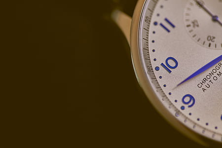 white chronograph watch needle pointing at 9 thumbnail
