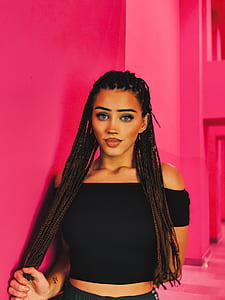selective focus of woman holding hair beside wall thumbnail