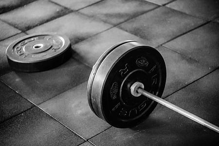 black barbell plates on floor thumbnail