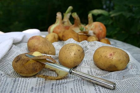 bunch of potatoes and peeler thumbnail