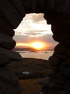 brown arch stone formation under sunset thumbnail