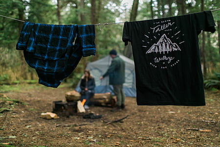 black T-shirt and blue clothe hanged on a wire thumbnail