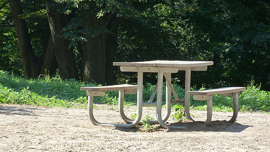 white wooden picnic table beside grass field thumbnail
