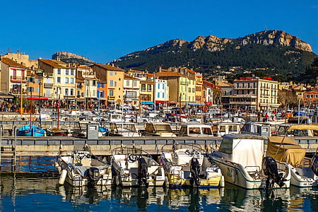 white boats on body of water beside boat docks thumbnail