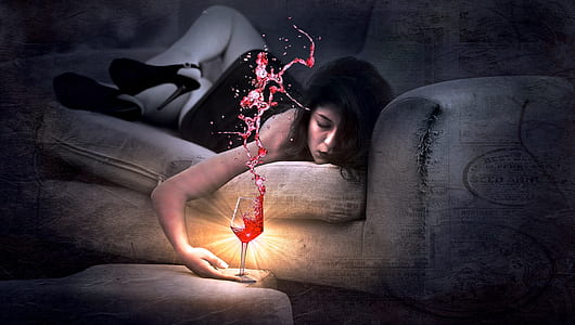 time lapse photo of woman lying on sofa holding wine glass filled with red liquid thumbnail
