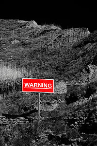 selective color of Warning signage on mountain thumbnail
