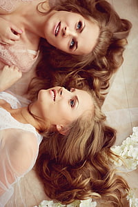 two smiling women wearing beige and white top thumbnail