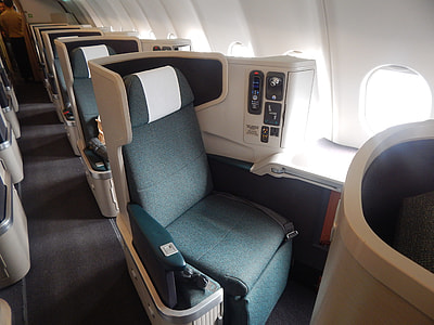 blue chair near window of aircraft thumbnail
