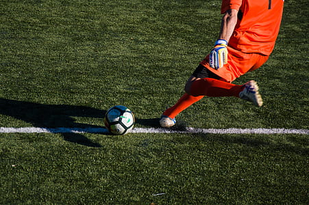 person about to kick soccer ball on field thumbnail