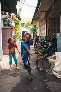 Child in Blue and Yellow Jersey Shirt With the Two Other Kids thumbnail