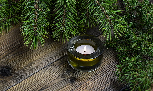 white tealight candle surrounded by garlands thumbnail