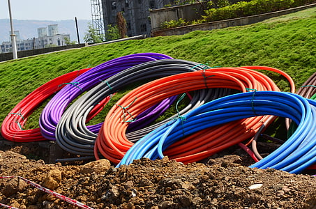 assorted-color hoses on green grass field thumbnail