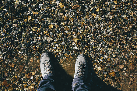 person standing on pebbles thumbnail