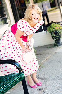 selective focus photography of woman in white and pink polka-dotted dress thumbnail