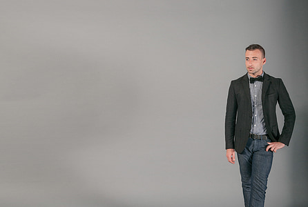 man in black suit jacket and dress pants posing for photo thumbnail