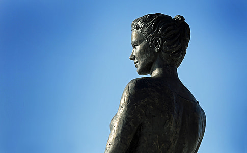 low angle photo of naked female statue under clear blue sky thumbnail