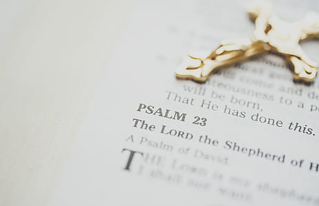 gold-colored cross pendant on bible showing Psalm 23 thumbnail