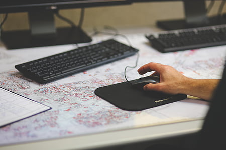person holding black corded computer mouse thumbnail