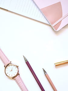 Flat lay Photography of Watch Near Pens and Notebook thumbnail