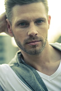 Man in White V-neck Shirt Looking Straight Profile thumbnail