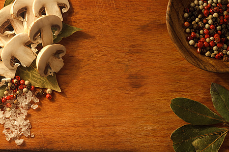 sliced mushroom on brown wooden table near bowl thumbnail