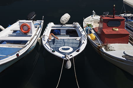 three assorted-color boats thumbnail