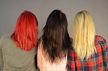 three woman with colored hairs wearing shirts thumbnail