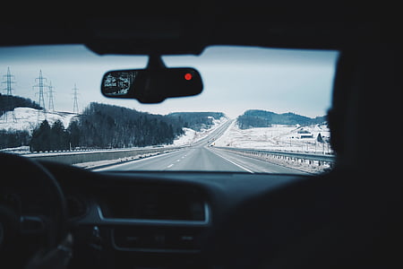 gray vehicle passing on gray road thumbnail