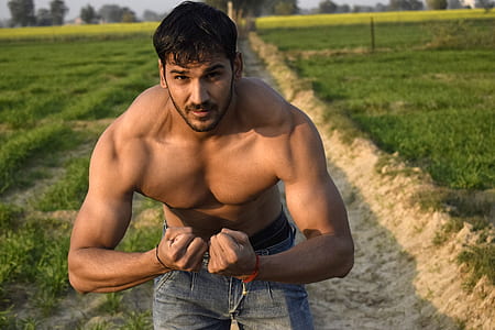 photo of man flexing on grass field thumbnail