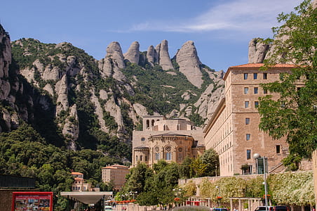 brown building near mountain during daytime thumbnail
