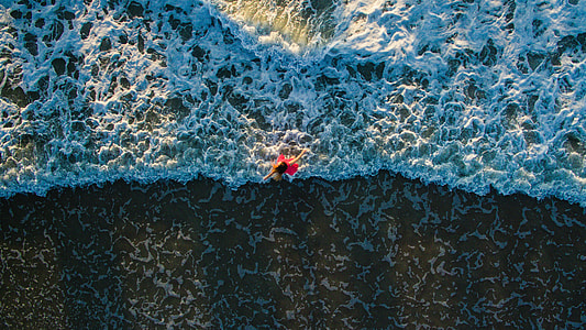 woman in red outfit on body of water thumbnail