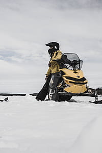photo of man sitting on snowmobile thumbnail