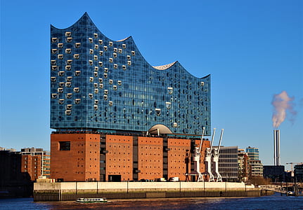 brown and blue building surrounded by body of water under clear blue sky thumbnail