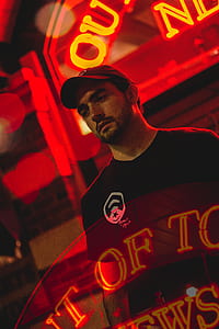 man in black crew-neck shirt and black baseball cap thumbnail
