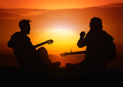 silhouette of men playing guitar during sunset thumbnail