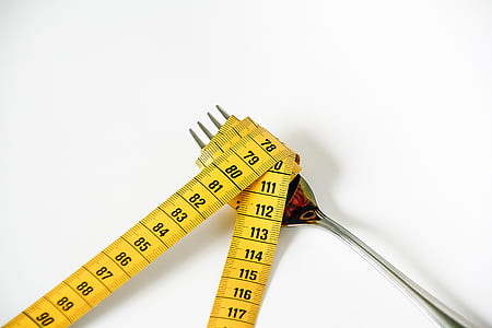 gray stainless steel fork wrapped with tape measure thumbnail
