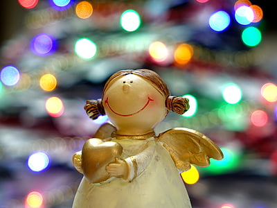 angel holding heart figurine with bokeh light thumbnail
