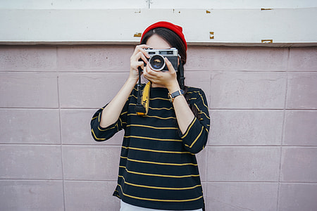person holding SLR camera thumbnail