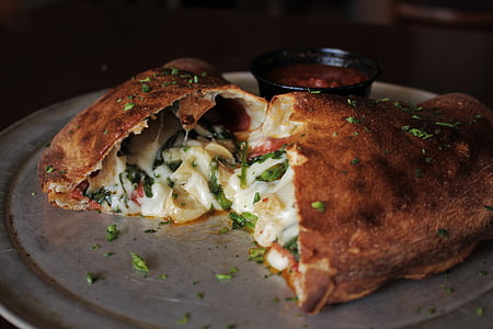 empanada with cheese on stainless steel plate thumbnail