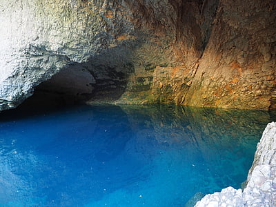 landscape photography of sea caves with calm water thumbnail