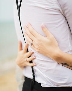 woman embracing man in white dress shirt thumbnail