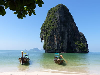 two boats near island during daytime thumbnail