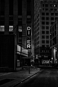 grayscale of turned on Pearl Diner LED signage near buildings at nighttime thumbnail