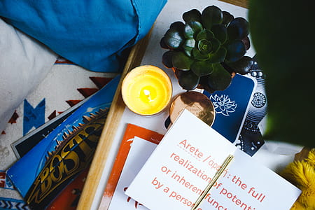 lighted tealight beside green succulent plant and white printer paper thumbnail