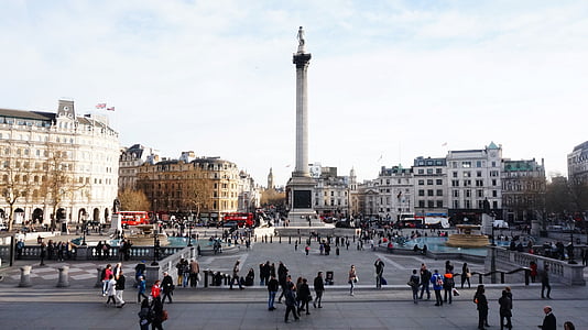 group of people walking near white concrete tower under white clouds and blue sky thumbnail
