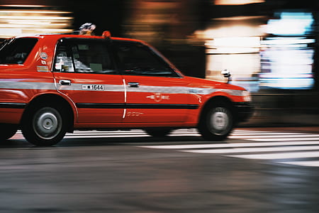 time lapse photography of red sedan thumbnail