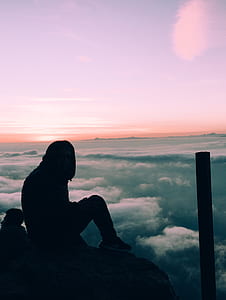 silhouette of person sitting under purple sky thumbnail